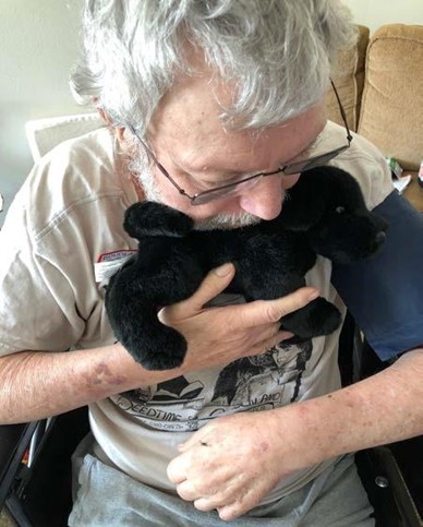 man cuddling a stuffed cat